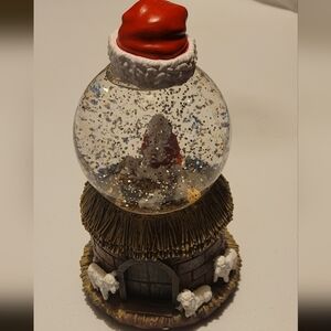 Electric Snow Globe With Santa, Baby Jesus, Lambs, A Red Hat, and Manger Barn
